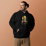 Adventure Before Dementia Camping Hoodie in Black, worn by a model against an orange background