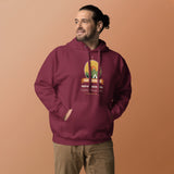 Adventure Before Dementia Camping Hoodie in Maroon, worn by a model against an orange background